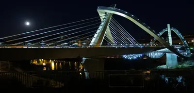 a bridge at night with the moon in the background at Motel Cancun Barbadas-Ourense in Os Fornos