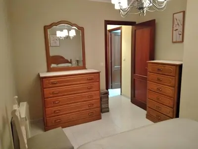 a bedroom with a dresser and a mirror at Cristel in Puentecesures