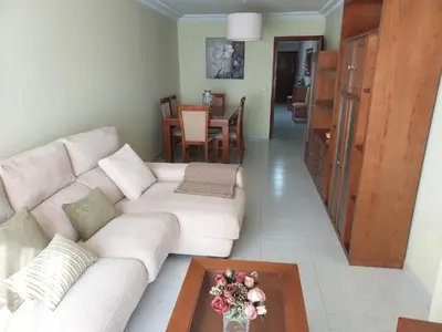 a living room with a white couch and a table at Cristel in Puentecesures