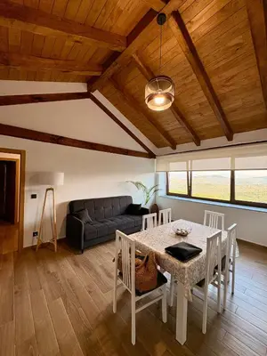 a living room with a table and a couch at Refuxio de Lamas in Becerreá