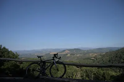 a bike parked on a fence overlooking a valley at Refuxio de Lamas in Becerreá