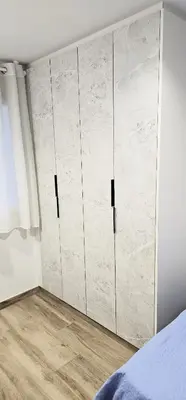 a bedroom with white walls and a large closet at Vacansis Santiago Garcia Prieto y Romero Donallo Habitaciones Privadas in Santiago de Compostela
