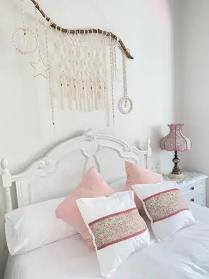 a white bed with pink and white pillows on it at Parque de los Condes in Monforte de Lemos