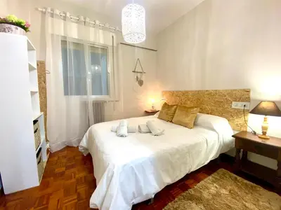 a bedroom with a white bed with two pillows on it at Parque de los Condes in Monforte de Lemos