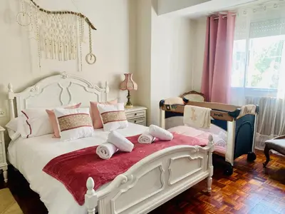 a bedroom with a large white bed with pillows at Parque de los Condes in Monforte de Lemos