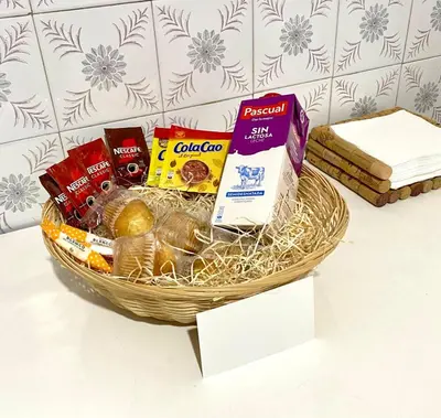 a basket of food and other snacks on a table at Parque de los Condes in Monforte de Lemos