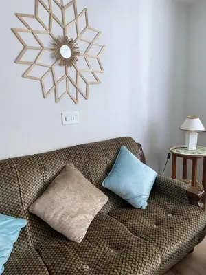a living room with a couch and a clock on the wall at Parque de los Condes in Monforte de Lemos