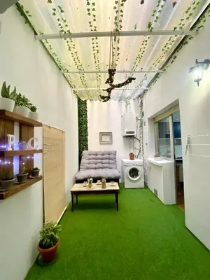 a living room with a couch and a washing machine at Parque de los Condes in Monforte de Lemos