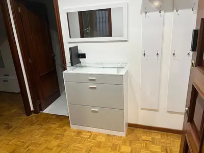 a bathroom with a counter with a sink and a mirror at Piso Artur III UNIVERSIDAD in Ourense