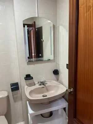 a white bathroom with a sink and a toilet at Piso Artur III UNIVERSIDAD in Ourense
