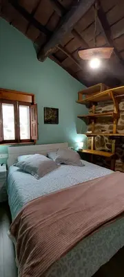 a bedroom with a large bed in a room at Casa dos ánxeles VUT-OR-1310 in Trasmiras
