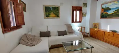 a living room with a white couch and a glass table at Casa dos ánxeles VUT-OR-1310 in Trasmiras