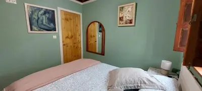 a bedroom with a bed and a mirror on the wall at Casa dos ánxeles VUT-OR-1310 in Trasmiras