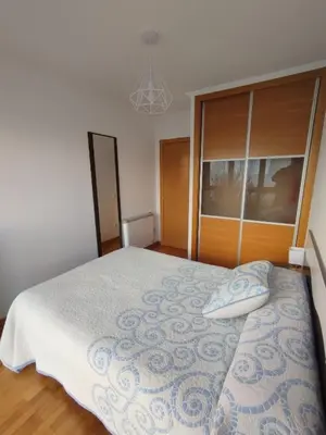 a bedroom with a large bed and a window at Hollyfoz Arenal in Foz