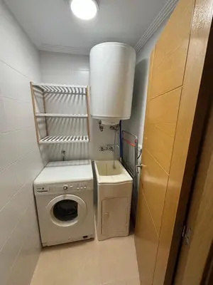 a small laundry room with a washer and dryer at Hollyfoz Arenal in Foz
