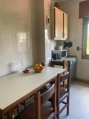 a kitchen with a table with a bowl of fruit on it at Casa Vilamarín in Santa Eulalia