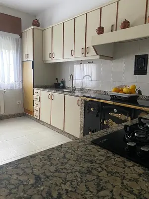 a kitchen with white cabinets and a sink and a stove at Casa Vilamarín in Santa Eulalia