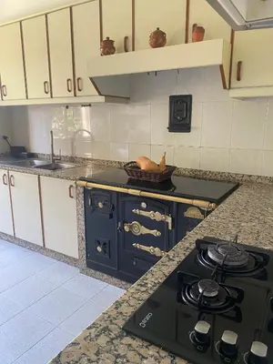 a kitchen with a black stove top in a kitchen at Casa Vilamarín in Santa Eulalia
