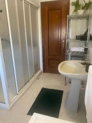 a bathroom with a sink and a toilet and a shower at Casa Vilamarín in Santa Eulalia