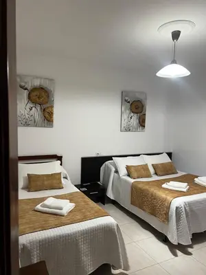 a bedroom with two beds with towels on them at Pensión Bodega de Ana in San Ciprián