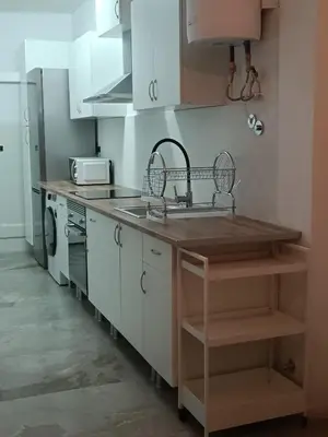 a kitchen with white cabinets and a sink at Piso en Pontedeume enfrente hotel Eumesa in Puentedeume