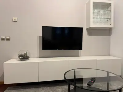 a white entertainment center with a flat screen tv on it at Caldas no Camiño in Caldas de Reis