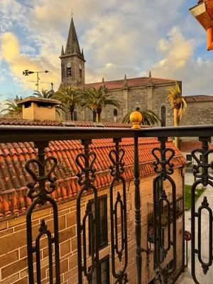 a view from a balcony of a building with a church at Caldas no Camiño in Caldas de Reis