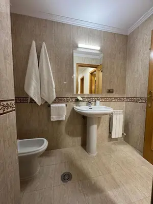 a bathroom with a sink and a toilet and a mirror at Caldas no Camiño in Caldas de Reis