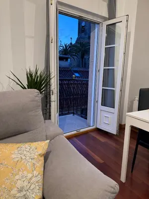 a living room with a couch and a sliding glass door at Caldas no Camiño in Caldas de Reis