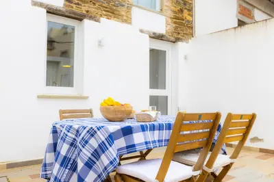 a table with a blue and white checkered table cloth at Casiña da Ribeira in Foz