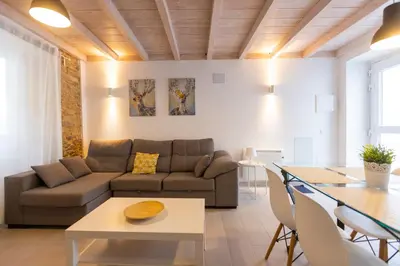 a living room with a couch and a table at Casiña da Ribeira in Foz