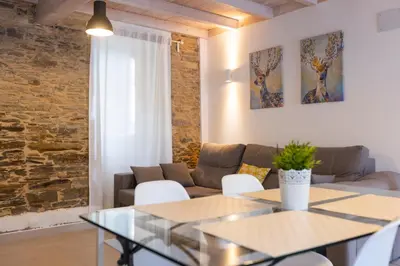 a living room with a couch and a table at Casiña da Ribeira in Foz