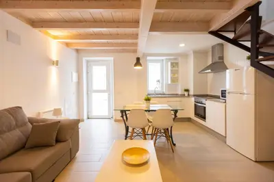 a living room with a couch and a table at Casiña da Ribeira in Foz