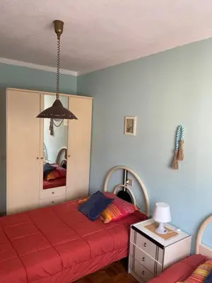 a bedroom with two beds and a mirror at Playa a Rapadoira - Foz in Foz