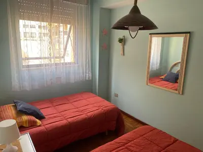 a bedroom with two beds and a mirror at Playa a Rapadoira - Foz in Foz