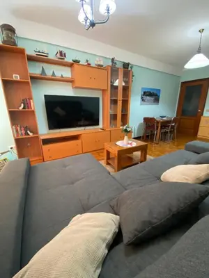 a living room with a couch and a flat screen tv at Playa a Rapadoira - Foz in Foz