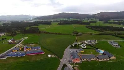 an aerial view of a house in a green field at El Capricho de Gonzalo in Cartavio