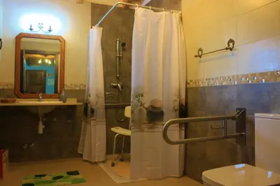 a bathroom with a shower and a toilet and a sink at El Capricho de Gonzalo in Cartavio