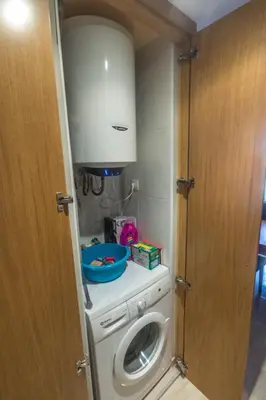 a washer and dryer in a small room at EnSAN CIPRIAN Urb con Playa y Piscina in San Ciprián