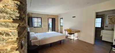 a bedroom with a bed and a desk in it at Casa Escuela Sanguñedo in Magdalena