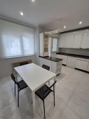 a kitchen with a white table and two chairs at Alfonso X Lucus Confort in Lugo