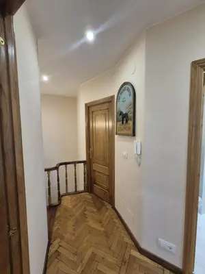a hallway with a wooden door in a house at Alfonso X Lucus Confort in Lugo