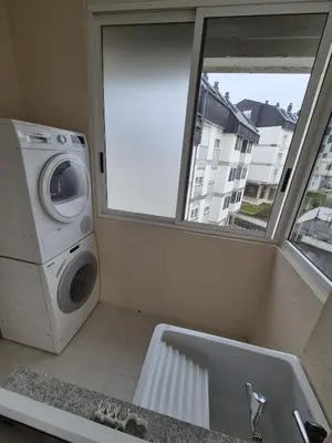 a bathroom with a washing machine and a sink at Alfonso X Lucus Confort in Lugo