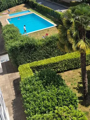 an overhead view of a man walking by a swimming pool at Alfonso X Lucus Confort in Lugo