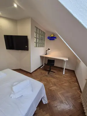 a bedroom with a bed and a desk and a tv at Alfonso X Lucus Confort in Lugo