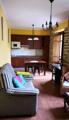 a living room with a couch and a table at Penouta in Boal