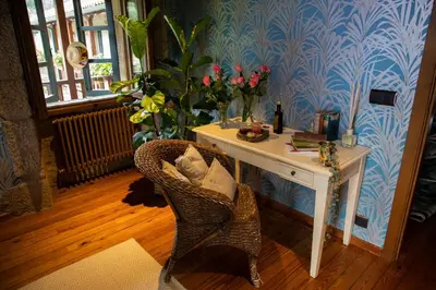 a room with a desk and a chair with flowers at Casal de Armán in Camporredondo
