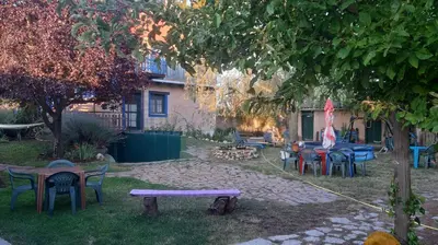 a group of tables and chairs in a yard at Alberguecasaflor in Murias de Rechivaldo