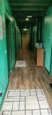 an empty room with green walls and wooden floors at Alberguecasaflor in Murias de Rechivaldo