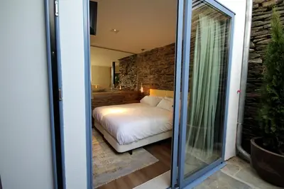 a bedroom with a bed in a room at Hotel Apartamentos Casas da Fortaleza in Lugo